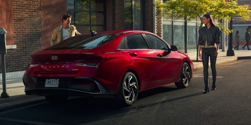 A 2024 Hyundai ELANTRA N parked on a city street, showcasing its sleek design and modern features.