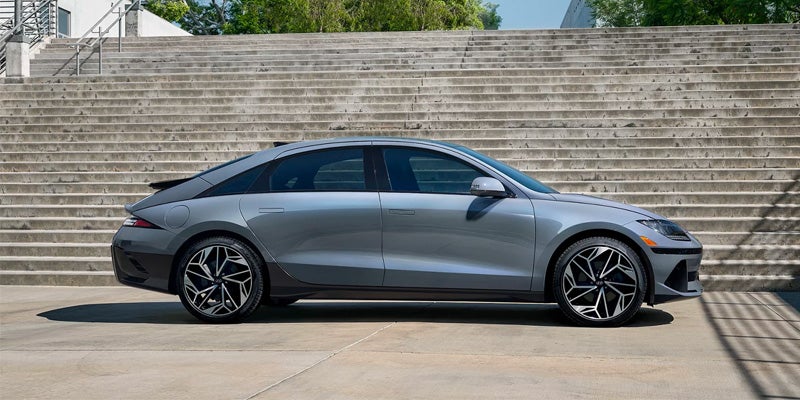 A 2024 Hyundai IONIQ 6 parked on stone steps, showcasing its sleek design and modern features.